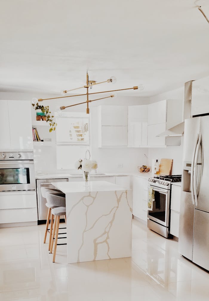 Mastering the First Impression: Your intriguing post title goes here A bright, modern kitchen featuring white cabinetry, stainless steel appliances, and minimalist decor.