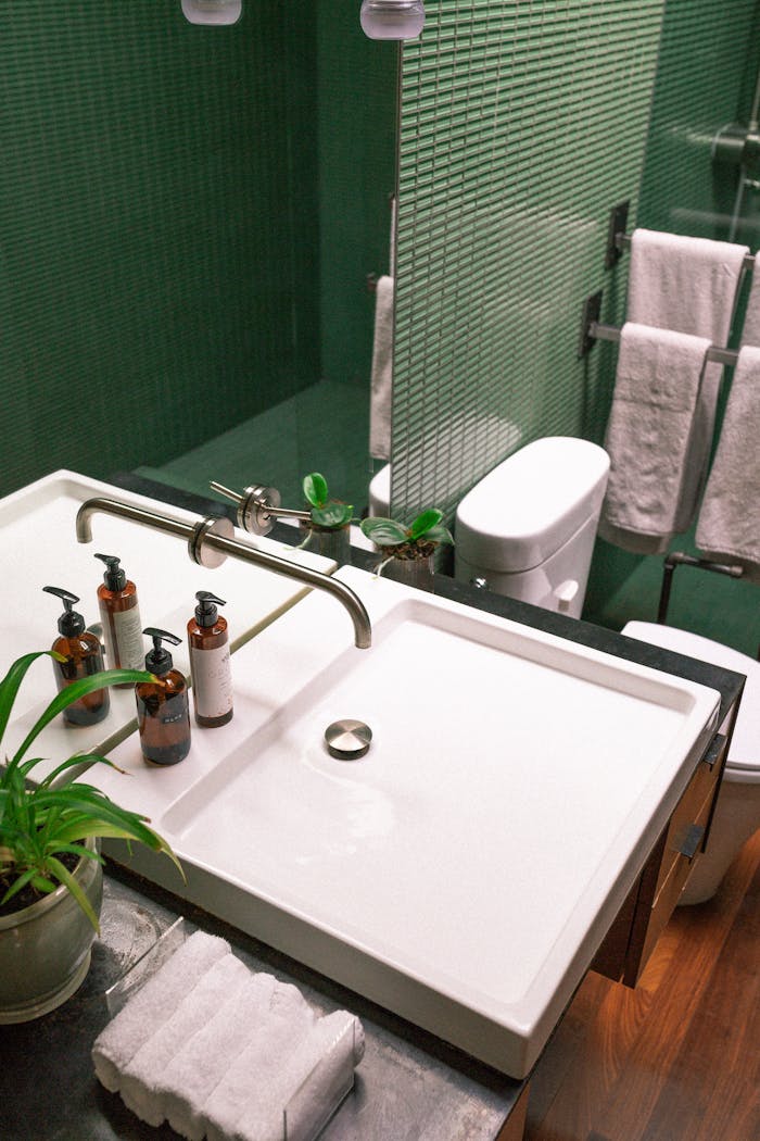 Crafting Captivating Headlines: Your awesome post title goes here Elegant green bathroom features modern sink and stylish fixtures.